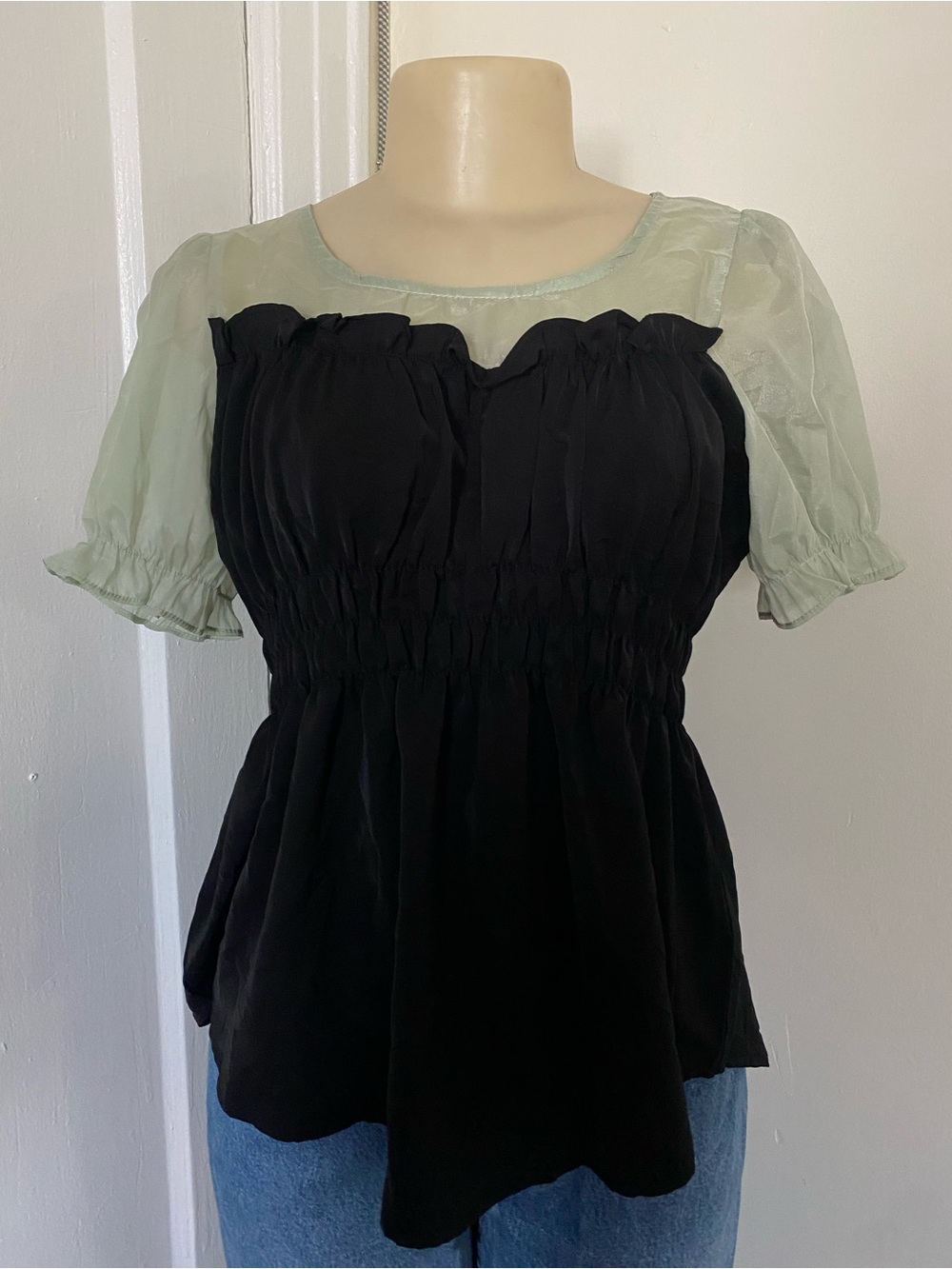 Black blouse with sage green sleeves